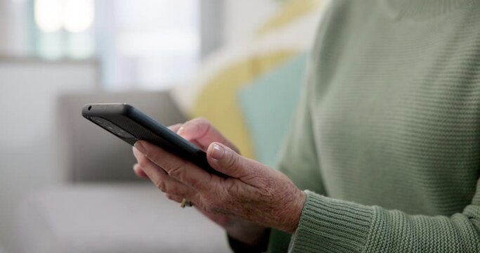 Phone, hands and senior woman typing a text message on social media or mobile app on a sofa. Technology, networking and closeup of elderly female person in retirement on a sofa on a cellphone at home