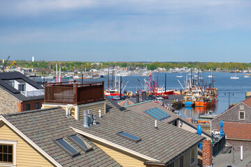 New Bedford harbor aerial view with fishing boats docked at piers near historic downtown of New Bedford, Massachusetts MA, USA. 