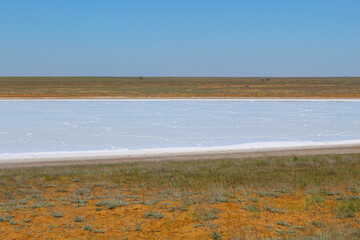 View of one of the salt lakes in the Astrakhan steppe on a sunny day. Russia
