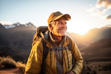 Fototapeta na wymiar Smiling portrait of a happy senior man hiker hiking in the forests and mountains