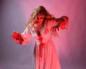 Close up portrait of  scary vampire bride wearing elegant halloween fantasy costume bloody...