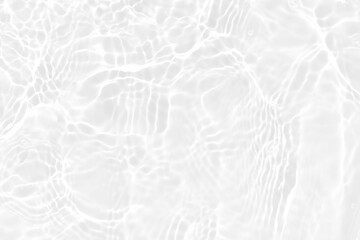 White water with ripples on the surface. Defocus blurred transparent white colored clear calm water surface texture with splashes and bubbles. Water waves with shining pattern texture background.