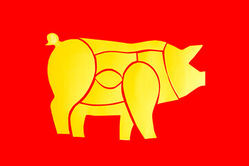 Bright yellow scheme of a pig carcass close-up on a red background © Лозовая Людмила