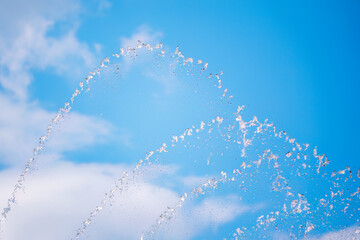 Splashes of water against the blue sky background