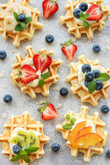 Freshly baked waffles with strawberries and blueberries