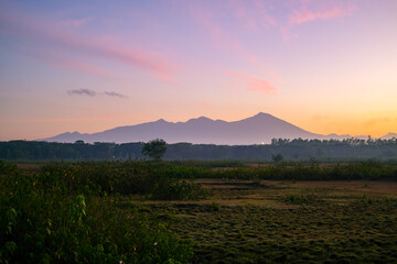 view of Mount Rinjani at sunrise in Lombok, sunrise and mountain view, sunrise in Lombok, sunrise over the mountains, mount Rinjani view in the morning, beautiful sunrise sky and mountain
