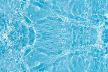  Blue water with ripples on the surface. Defocus blurred transparent blue colored clear calm water surface texture with splashes and bubbles. Water waves with shining pattern texture background.