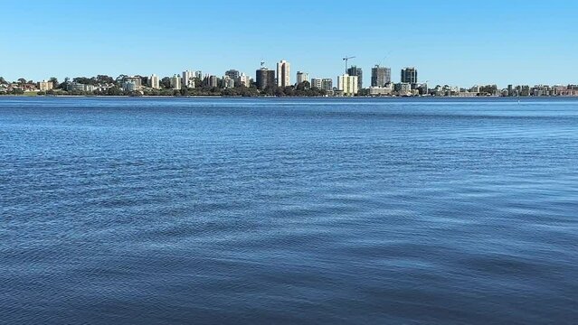 Across the vast blue water of the Swan River to the South Perth foreshore, Western Australia.