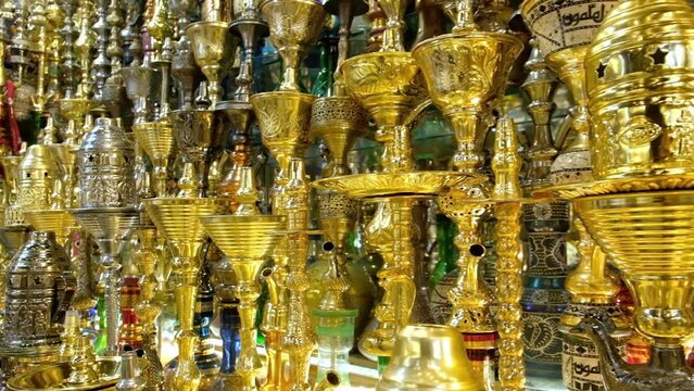 Shining waterpipes at souvenir shop. Rows of hookahs at market. Narghiles for sale at traditional middle eastern market. Khan El Khalili market, Cairo, Egypt