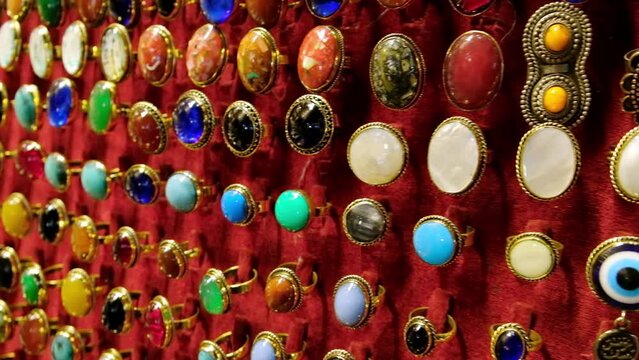 Rows of golden jewelry signets with semiprecious stones at traditional middle eastern bazaar. Jewelry rings for sale at Khan El Khalili bazaar, Cairo, Egypt