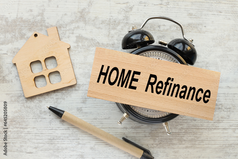Poster home refinance . business and financial concept. table clock gray background.text on wooden block