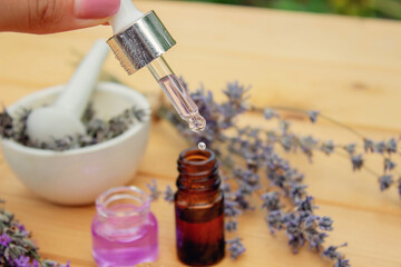 lavender essential oil, on a wooden background. Selective focus