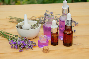 Fototapeta na wymiar lavender essential oil, on a wooden background. Selective focus