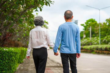 Obraz premium Elderly love, couple relaxing outdoors in blissful family time, peaceful moments, Mature asian husband and wife family time in natural serenity, heartwarming, relaxation