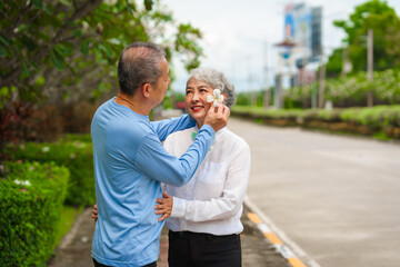 Fototapeta premium Elderly love, couple relaxing outdoors in blissful family time, peaceful moments, Mature asian husband and wife family time in natural serenity, heartwarming, relaxation