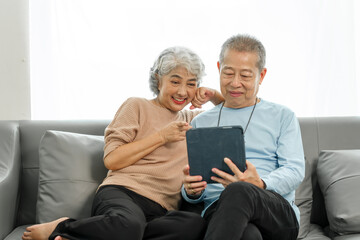 Blissful moments, elderly asian husband and wife sharing joy on sofa, timeless romance, heartwarming moments, peaceful harmony, timeless togetherness, happy family couple, grey hair