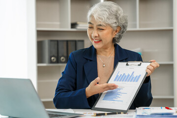 Mature businesswoman focused and dedicated while working at her office desk, Professional maturity, Experienced executive, Corporate competence