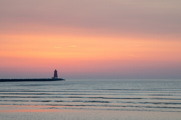 Lighthouse at dawn with large area of sky