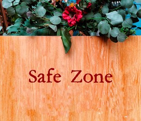 Welcome wood sign with text written SAFE ZONE, means places where people can feel safe - free of...