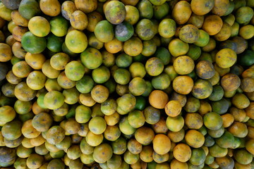 Piles of oranges being sold in a traditional market