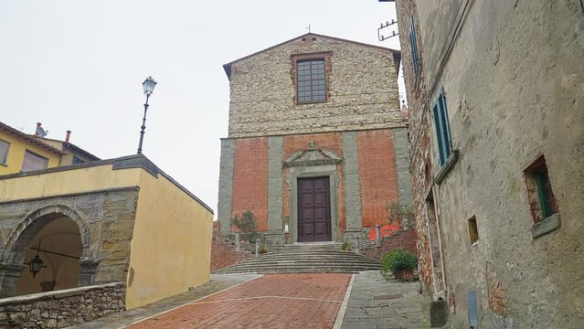 Renaissance Exterior Of Collegiata di San Michele Arcangelo, Catholic Church In The Town Of Lucignano, Tuscany, Italy. dolly-in tilt-up