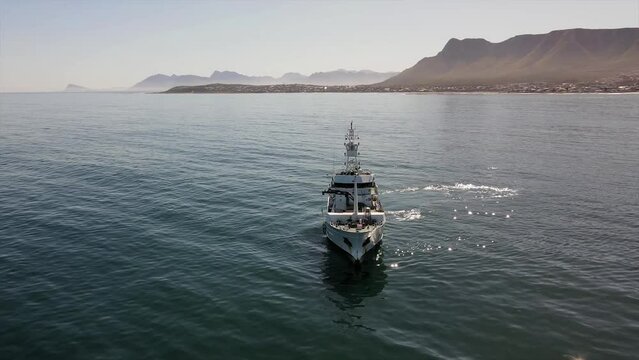 Motor vessel operating off the coast on a calm day