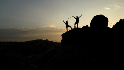Victory in Red: Two Climbers Reach the Peaks at Sunset