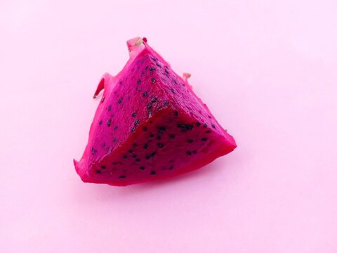 dragon fruit isolated on pink. Slices of fresh red dragon fruit on a pink background.
