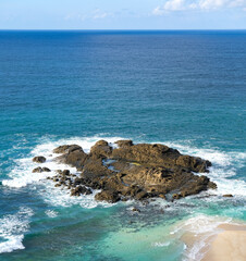view of the beach and rocks from the top of the merese hill in Lombok, waves and rocks, waves on the beach, waves crashing on the rocks, coast of island, sea and rocks, beach and rocks