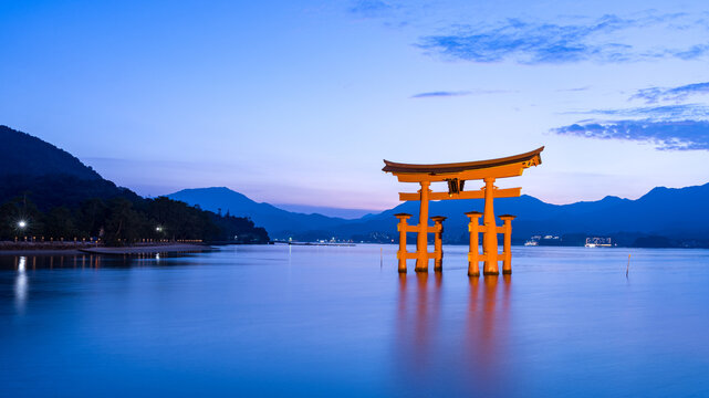 Hiroshima, Japan - July 27, 2023:  Itsukushima Shrine's torii gate at Miyajima in Hiroshima at magic hour.