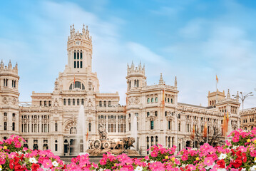 Spain, Madrid - Madrid City Hall building on Cibeles Square, flower garden in the foreground.