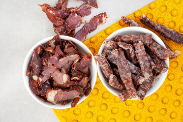 
South African Traditional Biltong and dry wors on yellow traditional printed cloth. 
