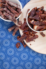 South African Traditional Biltong and dry wors on blue traditional printed cloth