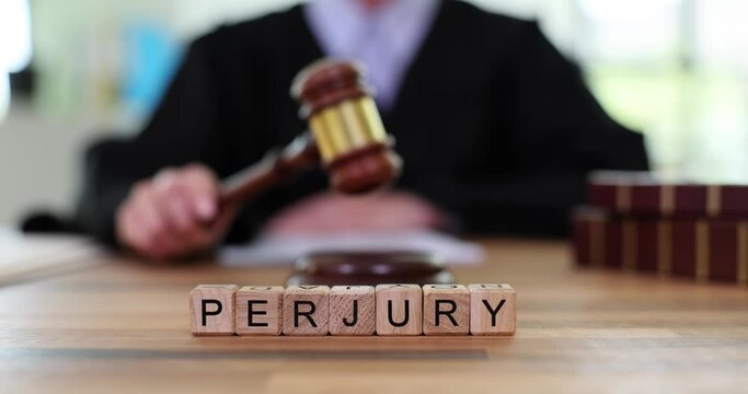Word perjury of wooden cubes against judge with gavel. Crime expressed in deliberate giving of knowingly false information to law enforcement agencies