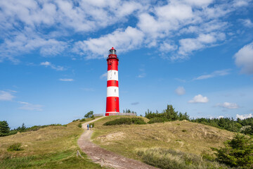 Fototapeta na wymiar Nordseeinsel Amrum, in den Dünen der Leuchtturm vor blauem Himmel