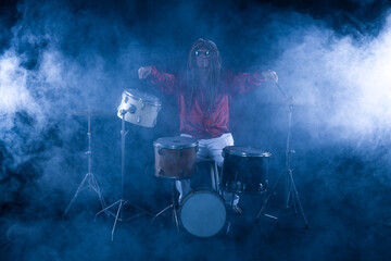 male drummer plays drums on a black background