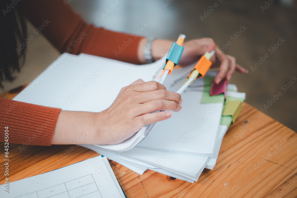 Poster businesswoman hands working in stacks of paper files for searching and checking unfinished document 