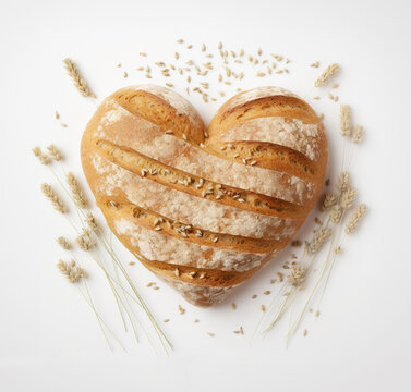 heart shaped bread with ears of wheat on white background
