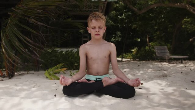 Concept of healthy lifestyle, kid boy daily meditation, relax time, harmony. Maldives islands. Mind practice. High quality 4k footage