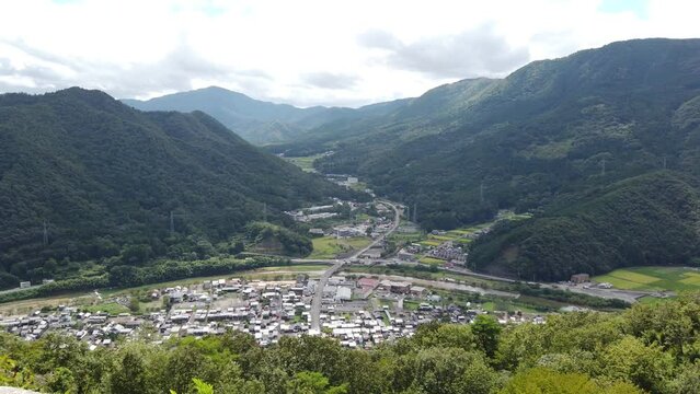 Pan across asago valley and city on overcast day, rich japanese history