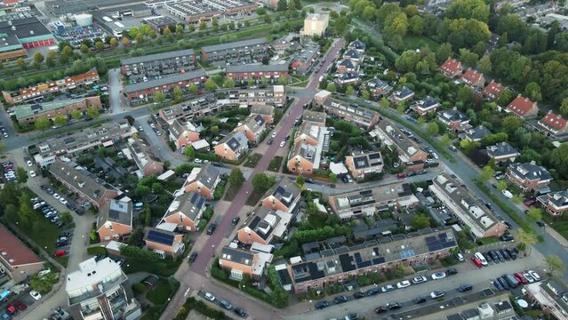 Aerial of a beautiful middle class neighborhood in a small town. Most of the houses have photovoltaic solar panels on rooftops