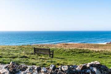 Bench with view of the cliffs on the north Cornish coast near Bude, England