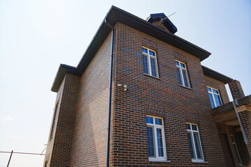 Large brick house with cctv camera on the wall.