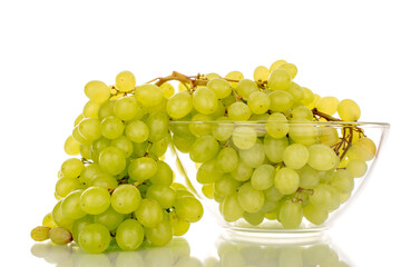 Sweet organic grapes in glass plate, macro isolated on white background.