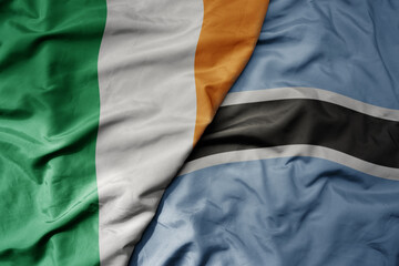 Fototapeta premium big waving national colorful flag of ireland and national flag of botswana .