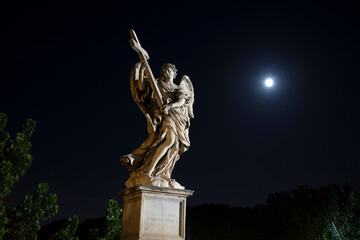 Statues on the castle and bridge of the Holy Angel, Rome, Italy, at night