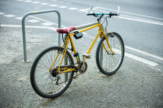 A parked yellow bike in the city of Barcelona. Sports are healthy concept. High quality photo