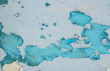 Peeling paint on the wall. Panorama of a concrete wall with old cracked flaking paint.