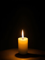 Obraz na płótnie Canvas a burning candle in the dark background