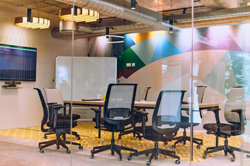 In the contemporary setting of an empty modern glass startup office, the space exudes a sleek and innovative atmosphere, ready to be filled with the potential of entrepreneurial endeavors